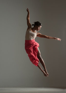 Black woman in red skirt dancing