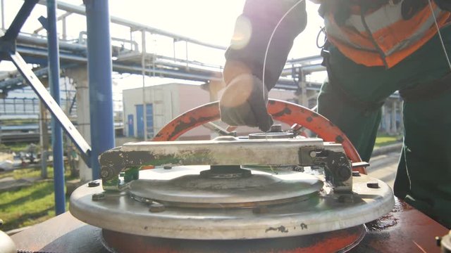 Closeup Skilled Worker Closes Cap on Reservoir and Makes Seal