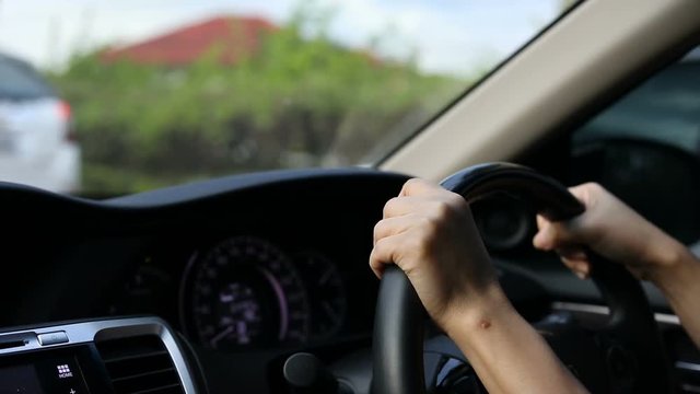 driving vehicle car with traffic jam on road city, hand driver control steering wheel
