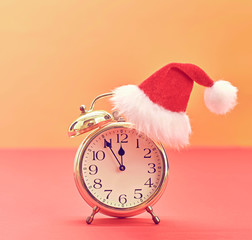New Year Christmas holiday Gold Alarm Clock, Santa hat. XMAS background decoration Handmade. Happy New Year Design Ornament. Festive Art christmas Colorful Greeting Card. Vintage