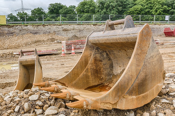 dredger bucket waiting to be picked up on a construction site