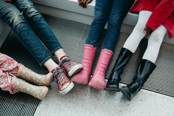 Boots and shoes of four young girls