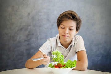 Teen boy refuses to eat salad