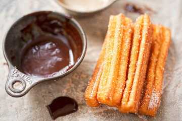 Churros with sugar and chocolate sauce 