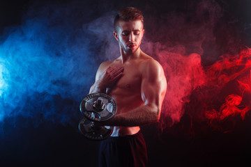 Impressive image of young handsome muscular man demonstrating perfect body. Power, strength,...