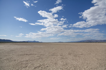 Crystal lake bed in the desert with blue skies and clouds