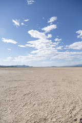 Fototapeta na wymiar Crystal lake bed in the desert with blue skies and clouds