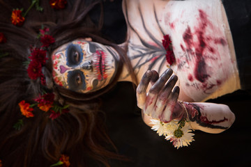 Beautiful girl with scary Halloween make-up