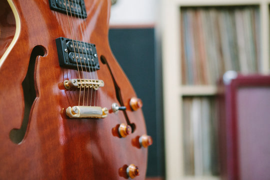 Guitar with amplifier in front of records