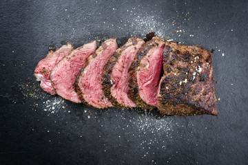 Barbecue dry aged caveman wagyu chateaubriand steak sliced as close-up on a board