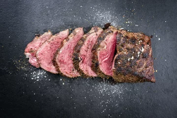 Zelfklevend Fotobehang Barbecue dry aged caveman wagyu chateaubriand steak sliced as close-up on a board © HLPhoto