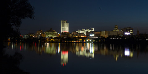 City of Albany lights and reflections on the Hudson River looking from the Renssalear docks in NY