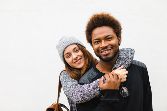 Portrait of young multi ethnic couple on white background.