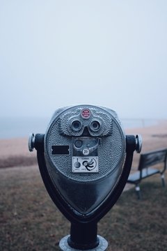 Binocular telescope camera on a foggy beach during the winter months in Maryland