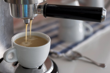 Professional coffee machine making espresso at home
