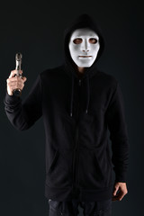 Man in a mask with a gun