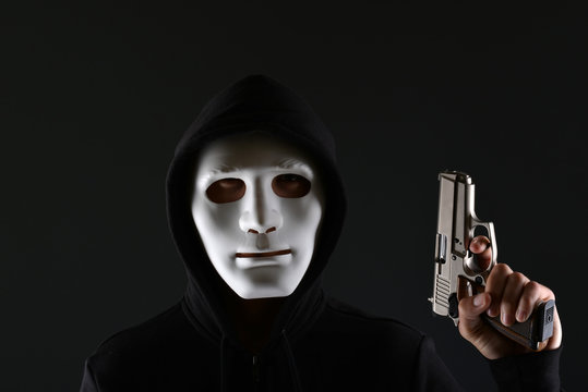 Man in a mask with a gun