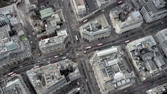 Aerial flight above buildings, roads and pedestrians in central London, England