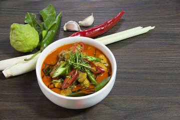Delicious chicken panang curry and ingredient spice on wooden background, thai food, selected focus.