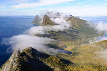 Segla and the village Fjordgåd on a summer day with fog