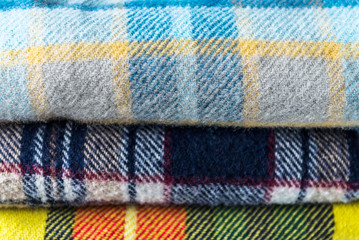 Fototapeta premium Stack of woolen checked blankets