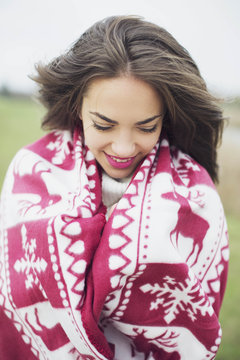 Girl wrapped in a blanket smiling