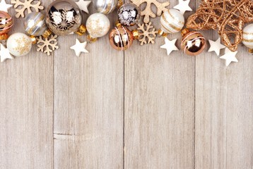 Christmas top border with white and gold ornaments on a rustic wood background