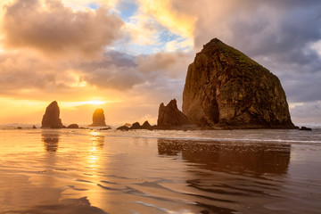 The sun sets behind Haystack Rock off the Oregon Coast