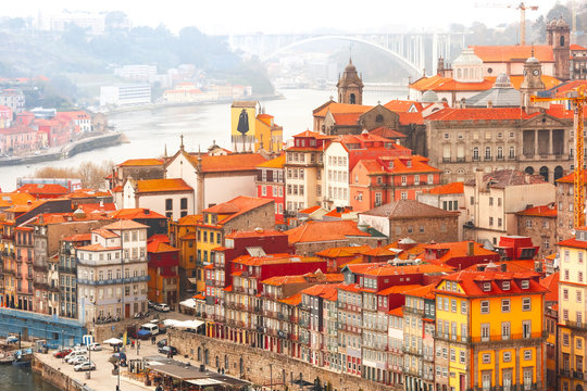 Aerial view with traditional multicolored quaint houses in Old town of Porto in the cloudy morning, Portugal