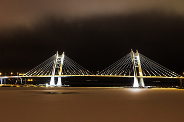 Fototapeta na wymiar Large bridge over river in winter night lights, Saint-Petersburg, the Western High-Speed Diameter