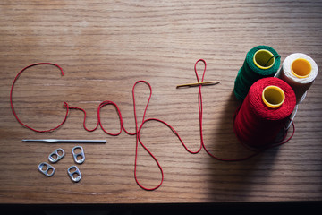 The words craft spelled out in yarn and other crafting items