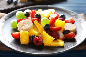 Delicious fruit salad on plate, closeup