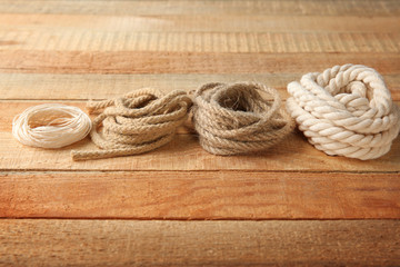 Fototapeta na wymiar Hemp ropes on wooden background