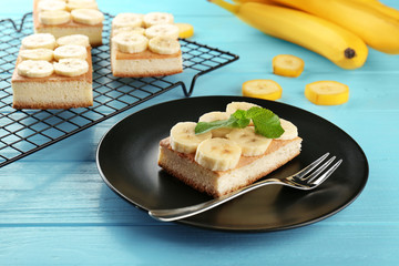 Plate with tasty banana cake on wooden table