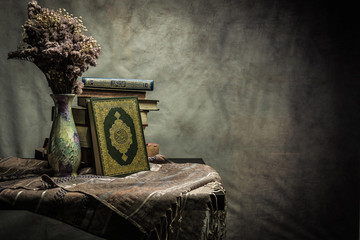 Koran - holy book of Muslims ( public item of all muslims ) on the table , still life