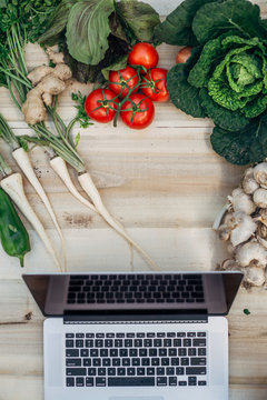 Table with computer and vegetables