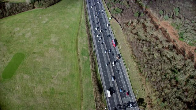 Aerial view of traffic driving on a motorway through the English countryside