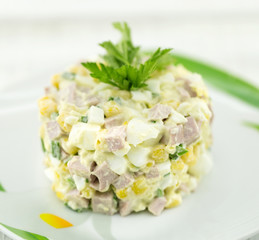 Salad from canned corn, sausage, eggs and onion
