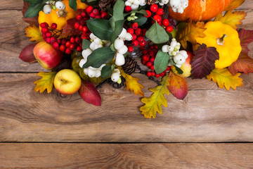 Thanksgiving background with rowan, apples, yellow squash, oak leaves, copy space