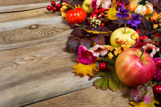 Thanksgiving centerpiece with apples, fall leaves, pink and purple flowers