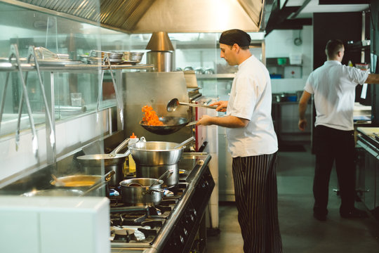 Chef preparing food at the restaurant kitchen