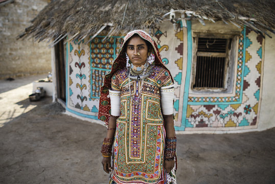 Ethnic Woman Near Traditional House