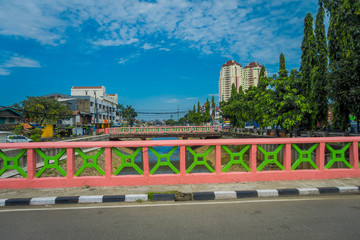JAKARTA, INDONESIA: View from small bridge showing some residence buildings in distance, beautiful blue sky