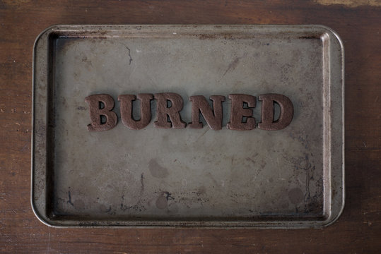 Shortbread Cookie Letters that have been burnt to a crisp, spelling out the word burned"""hortbre"