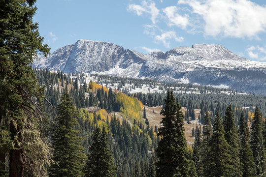 Gray rugged peaks dusted with snow in the San Juan mountains