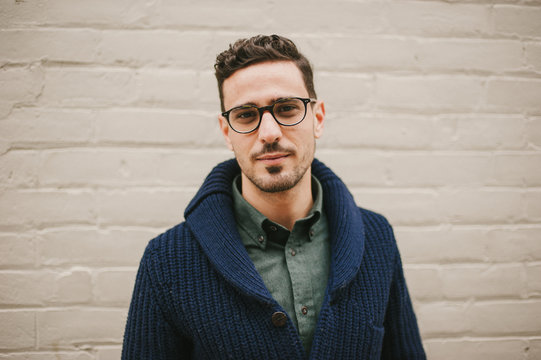 Attractive and fashionable young man wearing glasses