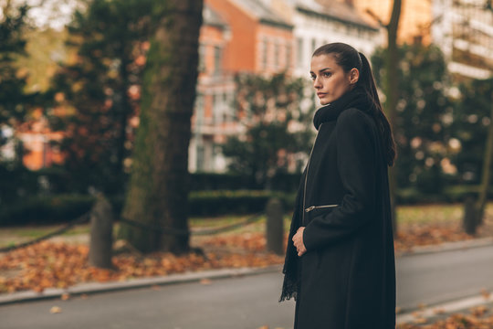 Beautiful Woman on the Street in the Autumn