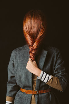 Woman hiding her face with a red braid