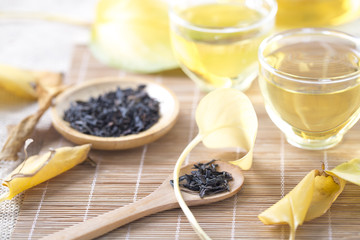 Autumn tea. Glass teapots and cups with autumn leaves on table.