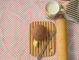  chocolate bun butter with milk on pink polka dot cloth, filtered tones